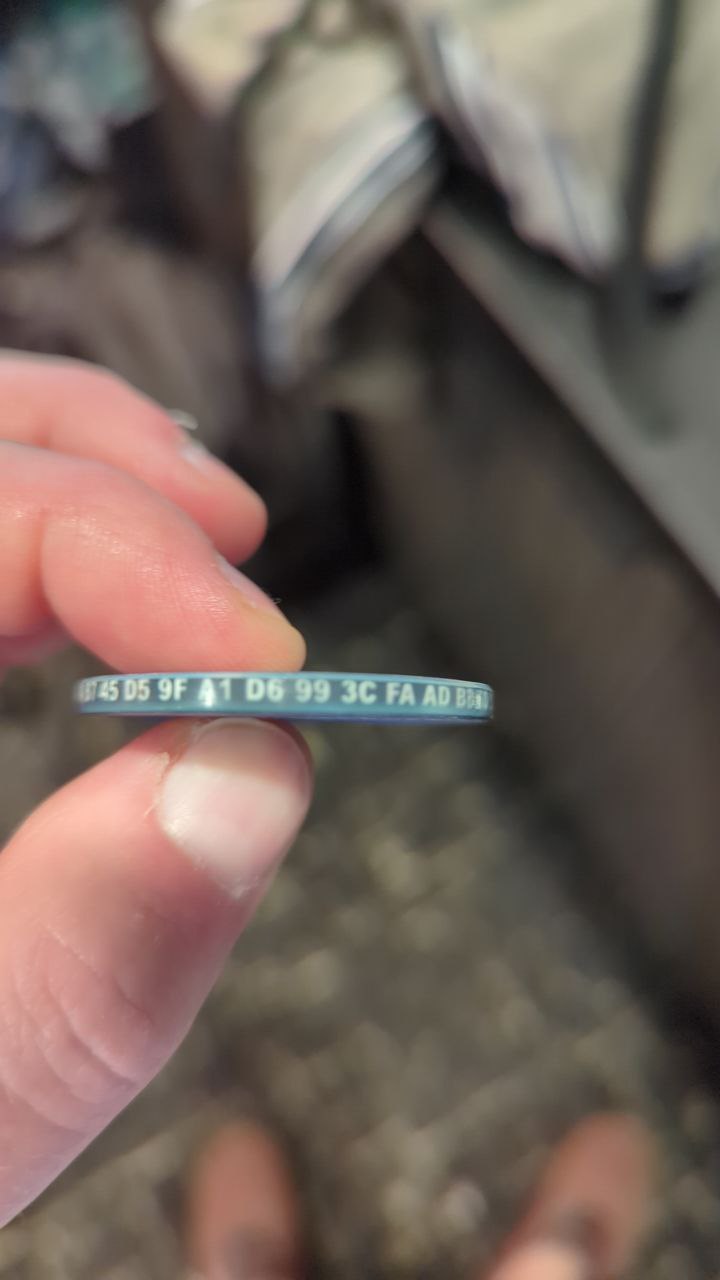 Edge of challenge coin with numbers and letters